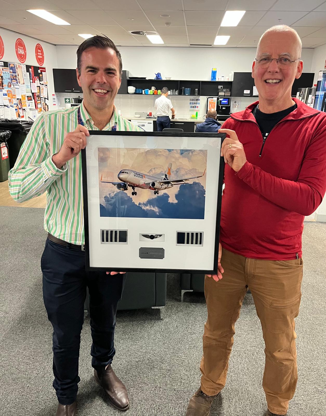 A framed aircraft photograph and commemorative display presented to its owner
